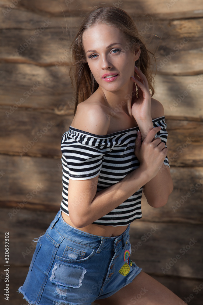 Portrait of beautiful young girl on wooden background. Portrait of beautiful young girl on wooden background.