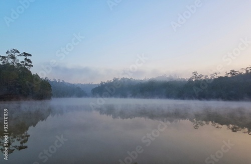 Fototapeta Naklejka Na Ścianę i Meble -  mountain view  foggy basin floating on the water surface