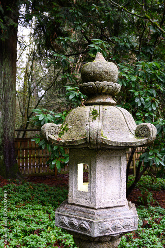 Cement Japanese lantern in a peaceful garden, lit up inside