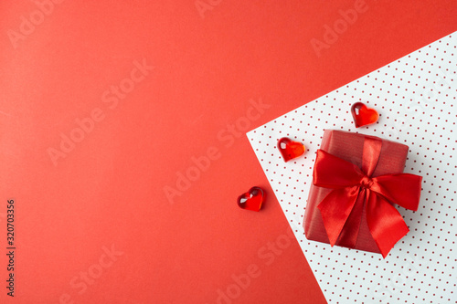 Valentine's day background with elegant gift and hearts on wrapping paper