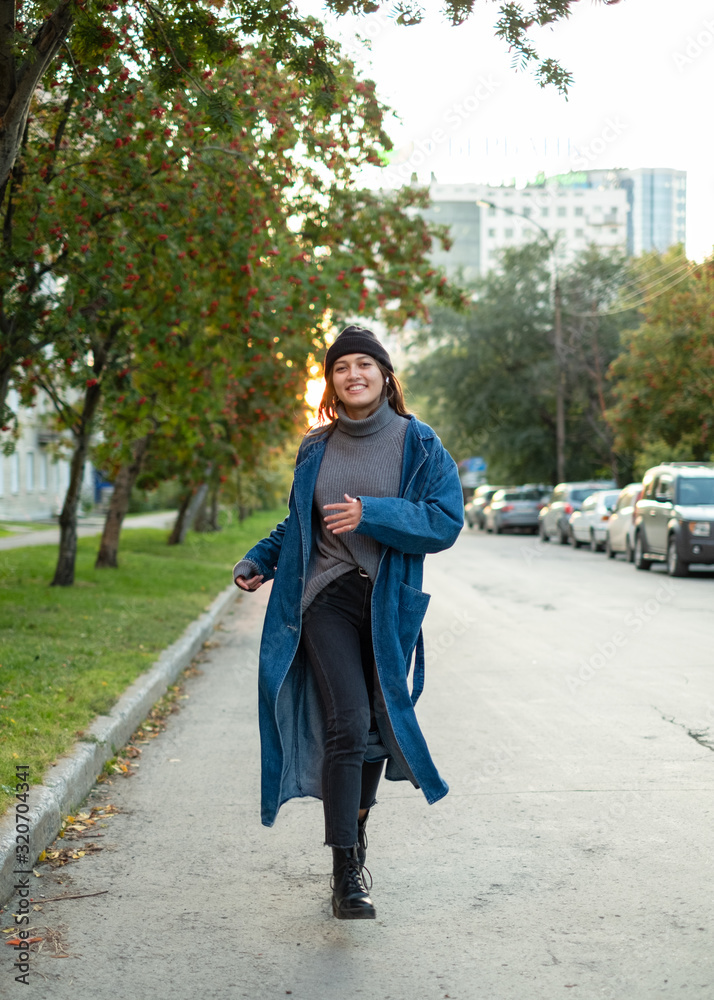 girl in stylish hipster outfit running and having fun. Exiting emotions. Autumn mood. Wearing gray sweater. Fashion. girl in stylish hipster outfit running and having fun. Exiting emotions. Autumn mood. Wearing gray sweater. Fashion.