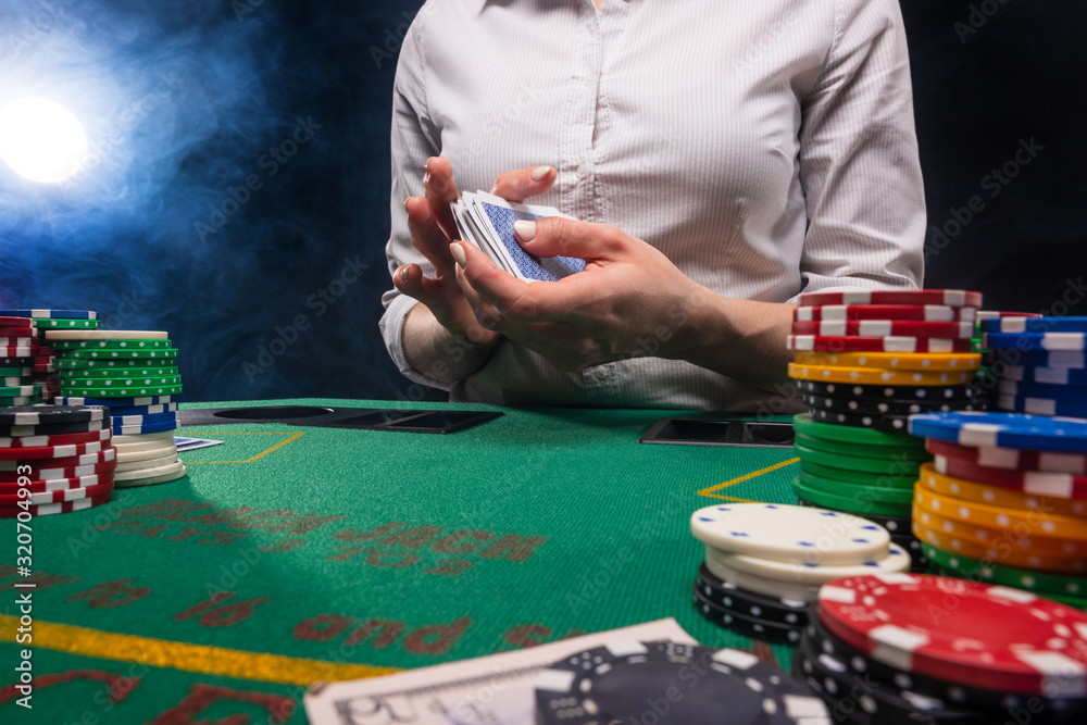 Gambling and gaming business in a casino. Girl hands out cards. Concept of playing cards. Gambling and gaming business in a casino. Girl hands out cards. Concept of playing cards.