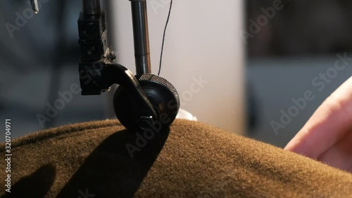 Sewing Machine Needle in Motion. Close-up of sewing machine needle rapidly moves up and down.