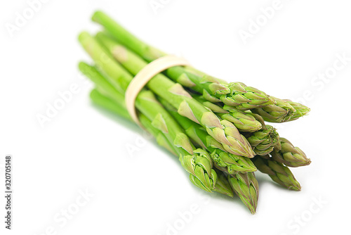 Bunch of fresh organic green asparagus on white background photo