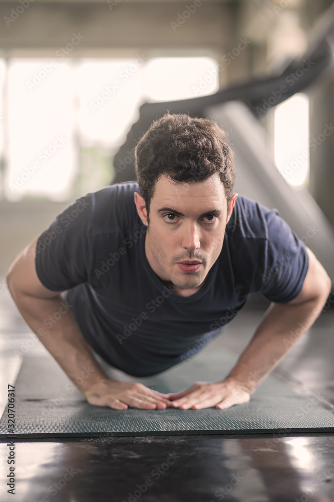 Handsome man and strong guy doing push ups exercise in fitness gym Handsome man and strong guy doing push ups exercise in fitness gym