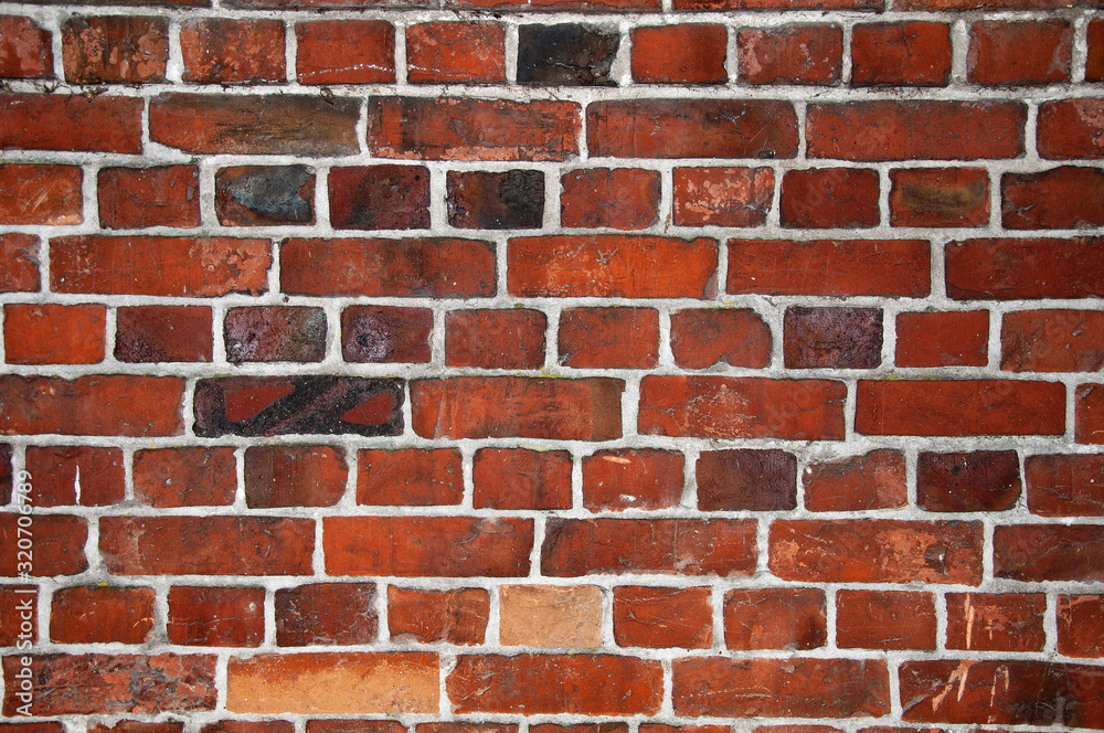 Old red cracked brick wall texture. Surface and backound for web design.