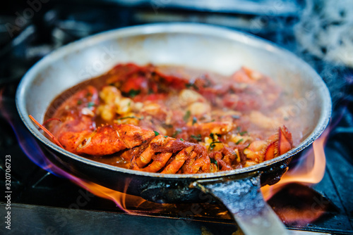 Lobster pasta being cooked over the stove photo