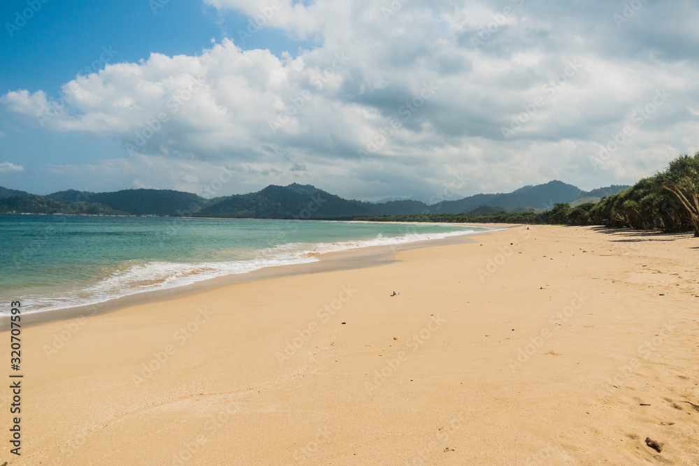 Beautiful empty beach on a clear summer day with blue sky and white beach Beautiful empty beach on a clear summer day with blue sky and white beach