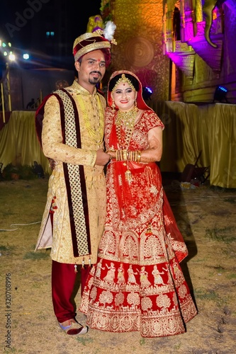 A Young Couple Posing With Traditional Outfit In Indian Wedding.