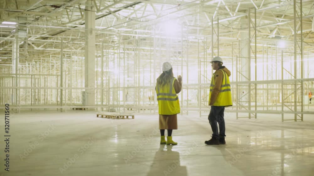 engineer with taskmaster inspects future shopping mall engineer with taskmaster inspects future shopping mall