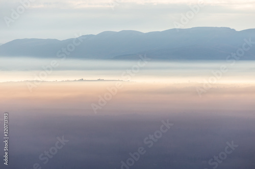 Sea of fog and mist between mountains and hills © Massimo