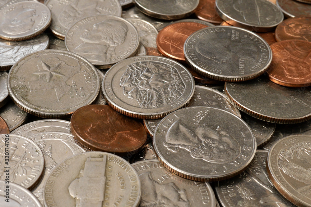 American money. Large pile of coins of American cents of different denominations. Financial background. Selective focus. American money. Large pile of coins of American cents of different denominations. Financial background. Selective focus.