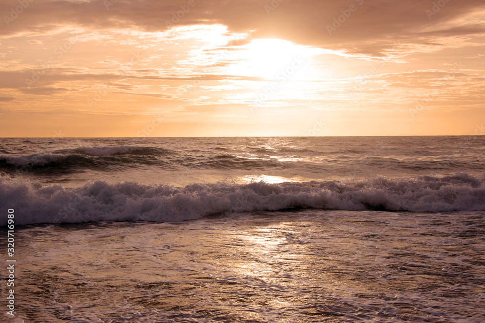 Fototapeta premium Beautiful sunset on tropical beach. The surf pounds the shore. Karon beach, Phuket, Thailand