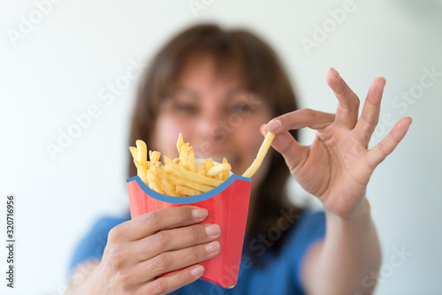 Woman Holding a Box with French Fries.