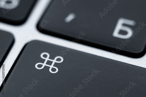 Close-up of a black command key on a keyboard. Function key to control.