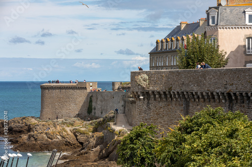 Tourists walking on rampart at Saint-Malo, Brittany, France