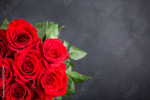 Bouquet of red roses.  Beautiful flowers on a black background. Top view, copy space.