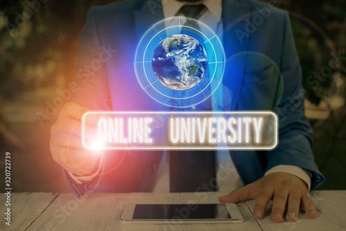 Text sign showing Online University. Business photo text provides education programs through electronic media Elements of this image furnished by NASA photo