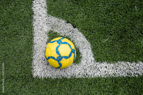 Ball on marked soccer football field corner