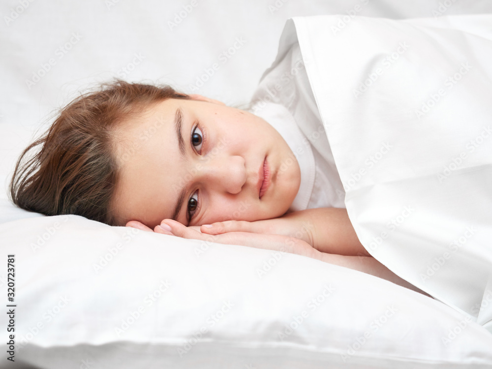 sick girl lying in white bed with a thermometer. . coronavirus sick girl lying in white bed with a thermometer. . coronavirus