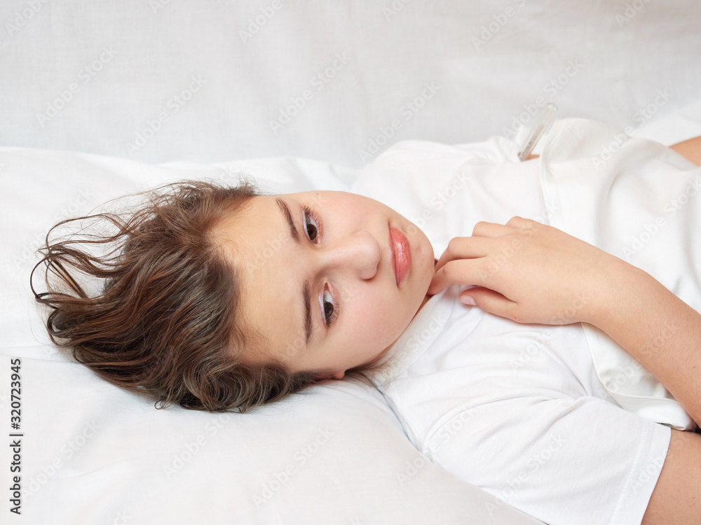 sick girl lying in white bed with a thermometer. . coronavirus sick girl lying in white bed with a thermometer. . coronavirus