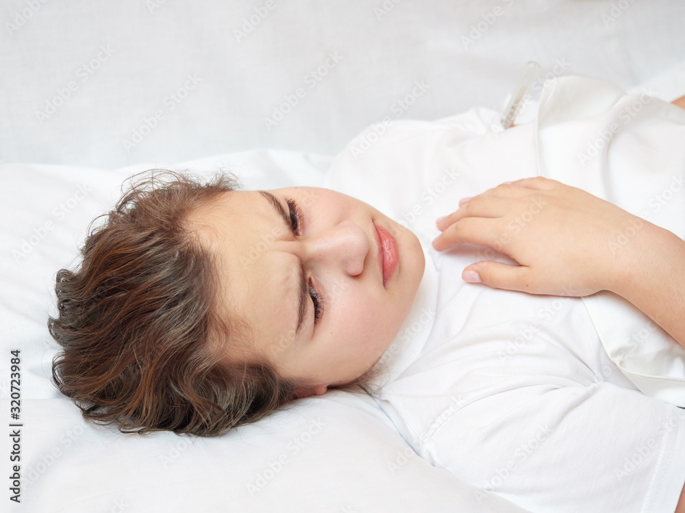 sick girl lying in white bed with a thermometer. . coronavirus sick girl lying in white bed with a thermometer. . coronavirus
