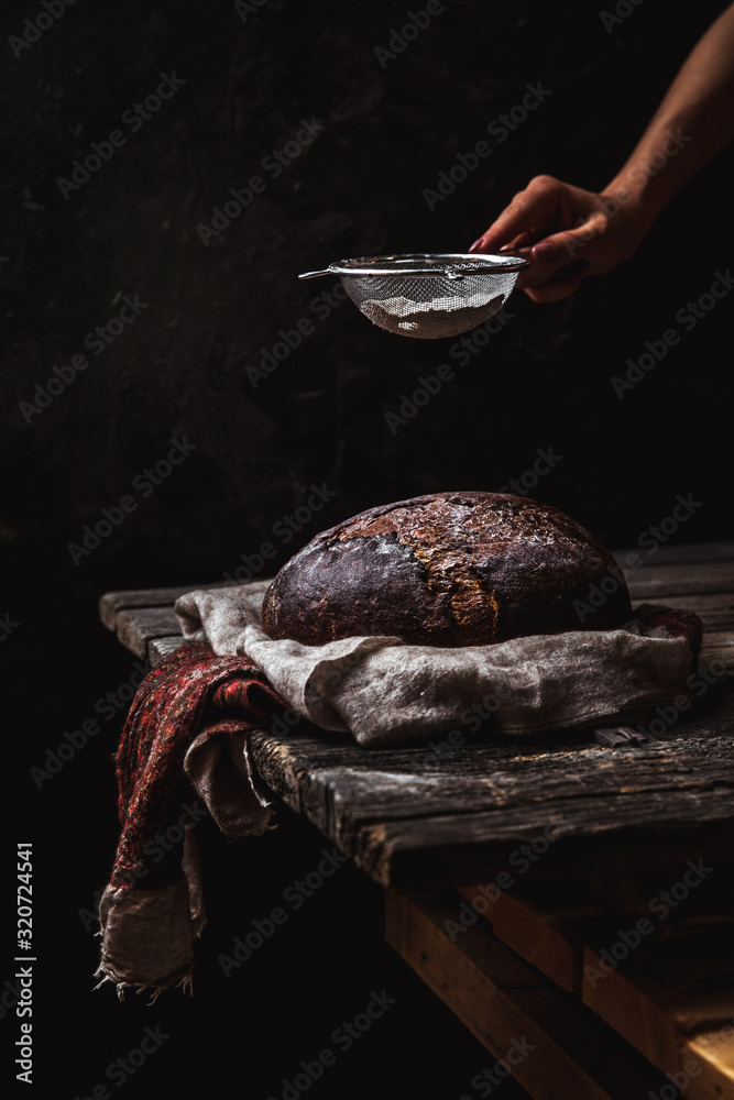 Bread on a rural on a black background. homemade baking
