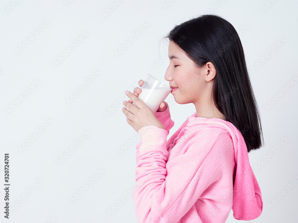 Cheerful girl drinking milk fresh. Cheerful girl drinking milk fresh.