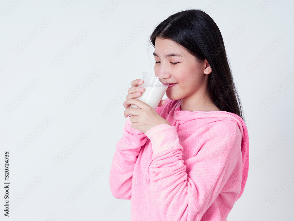Cheerful girl drinking milk fresh. Cheerful girl drinking milk fresh.
