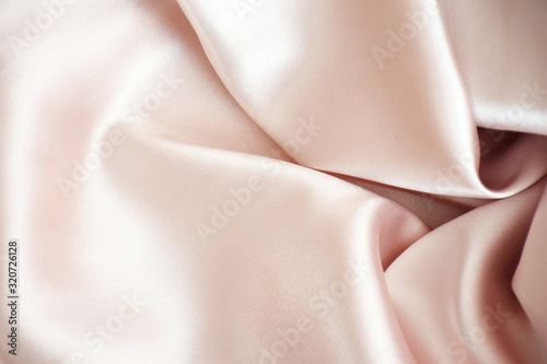 Romantic gentle pink texture with copy space. Texture, background, pattern, pink silk fabric, smooth shiny tight weaving, photo studio. Pink, burgundy-pink, fabric color, light and shadow unique.