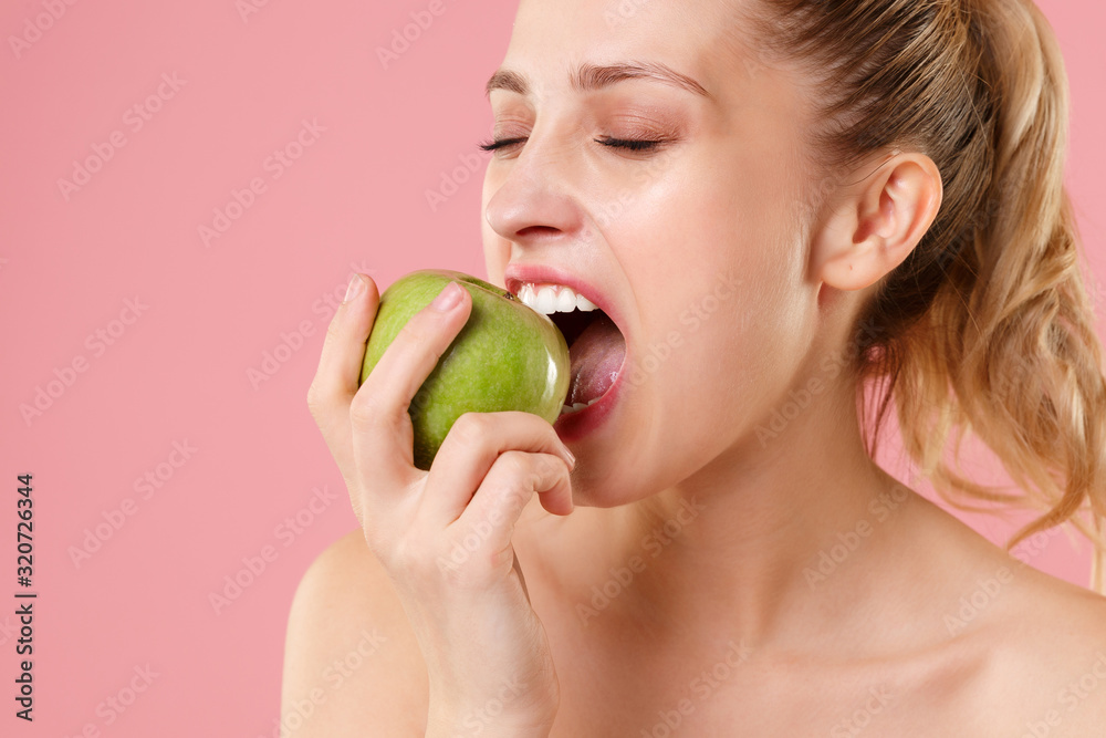 Close up blonde half naked woman 20s perfect skin nude make up hold apple isolated on pastel pink wall background studio portrait. Skin care healthcare cosmetic procedures concept. Mock up copy space. Close up blonde half naked woman 20s perfect skin nude make up hold apple isolated on pastel pink wall background studio portrait. Skin care healthcare cosmetic procedures concept. Mock up copy space.