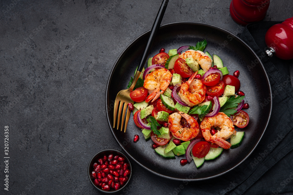 grilled shrimps and vegetable salad on black plate grilled shrimps and vegetable salad on black plate
