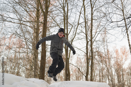 boy jumping from a mountain covered in snow. winter games outdoor