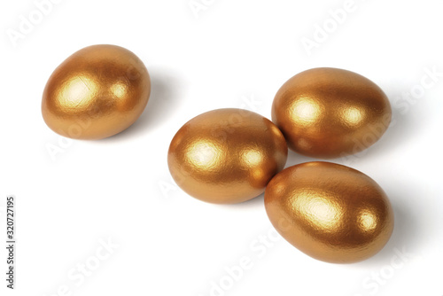 Golden eggs on a white background