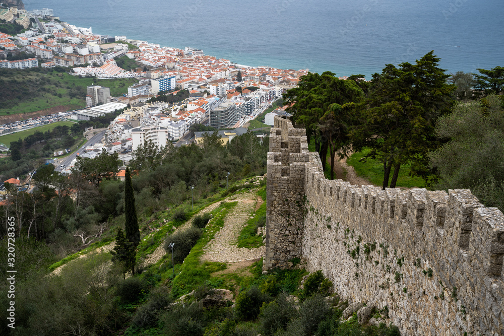 Beautiful aerial view of Sesimbra, Portugal - as seen from the castle on the hill, with defensive castle walls