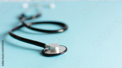 Doctor's stethoscope on blue background.