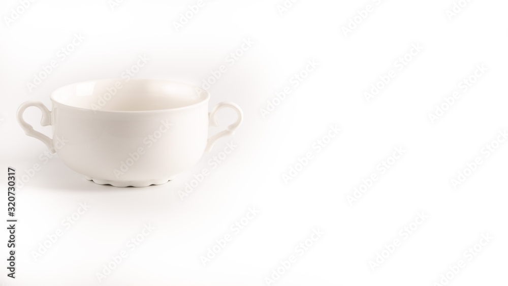 White empty soup bow with handles isolated on a white background. White empty soup bow with handles isolated on a white background.