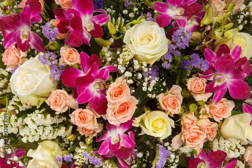 Backdrop of colorful paper roses background in a wedding reception with soft colors. Closeup image of beautiful flowers wall background with amazing red and white roses. Top view