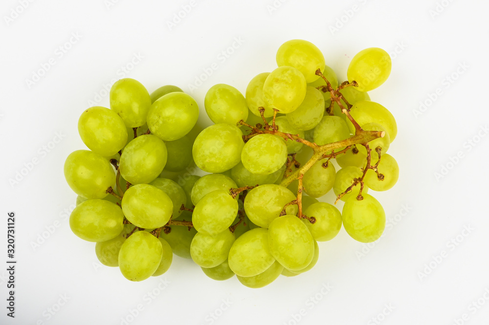 Large green juicy grape on a white background. Flat lay. view from above. Place for writing. A bunch of green grapes