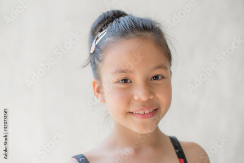 Wallpaper Mural portrait of a happy smiling beautiful and confident child girl, laughing child expressive facial expressions, space for text, joy on the kid face on a light background, fun and joyful concept Torontodigital.ca