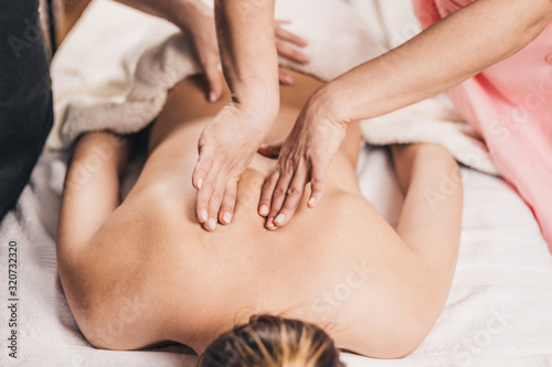 Massage in the area of the scapula female masseur - back massage