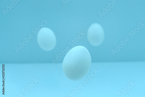 Flying easter eggs on light background.