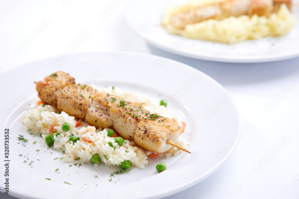 chicken kebab with rice and vegetables on the white background chicken kebab with rice and vegetables on the white background