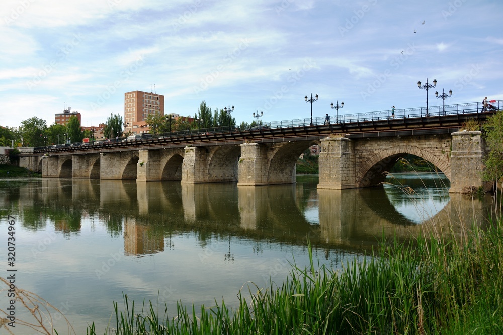 An old bridge reflected on the river