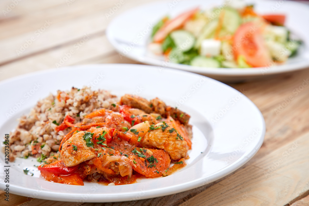 meat with buckwheat and salad on the wooden background meat with buckwheat and salad on the wooden background