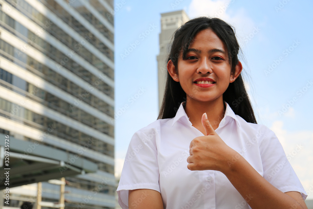 Beautiful Asia girl teen smile portrait and building in the city background.