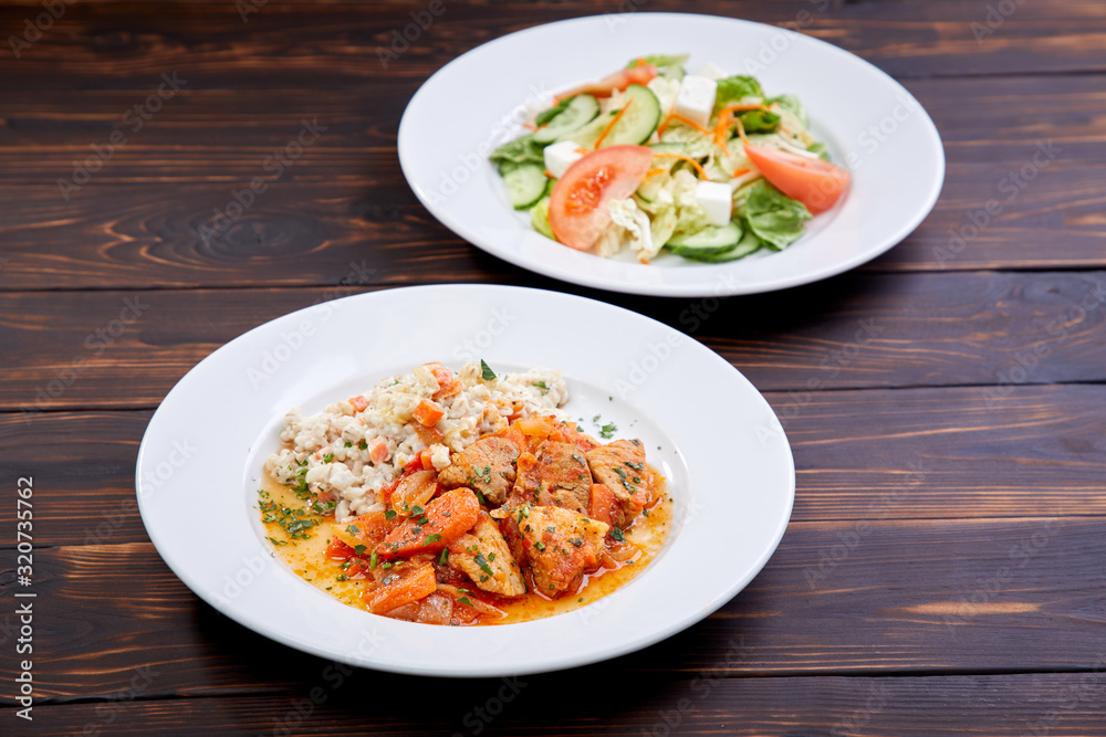 meat with barley and salad on the wooden background meat with barley and salad on the wooden background
