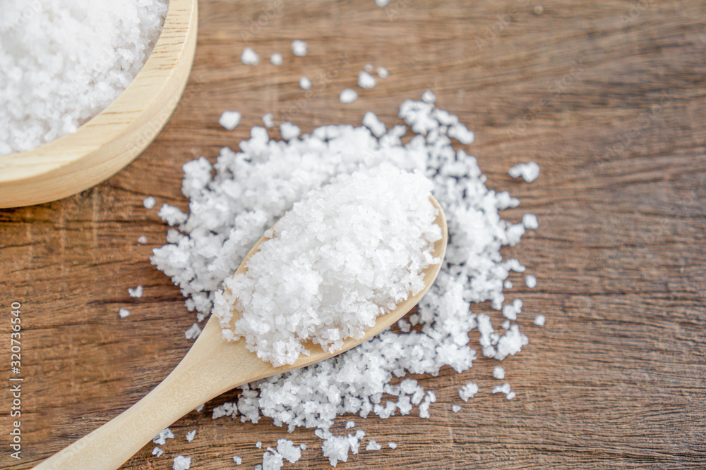 closeup salt oin wooden spoon on table closeup salt oin wooden spoon on table
