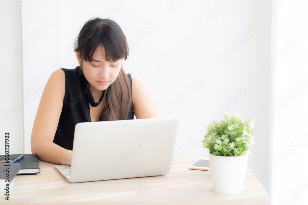 Beautiful freelance asian woman smiling working and typing on laptop computer at desk office with professional, girl using notebook checking email or social network, business and lifestyle concept. Beautiful freelance asian woman smiling working and typing on laptop computer at desk office with professional, girl using notebook checking email or social network, business and lifestyle concept.