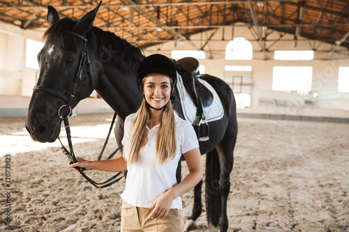 Beautiful woman wearing hat with horse
